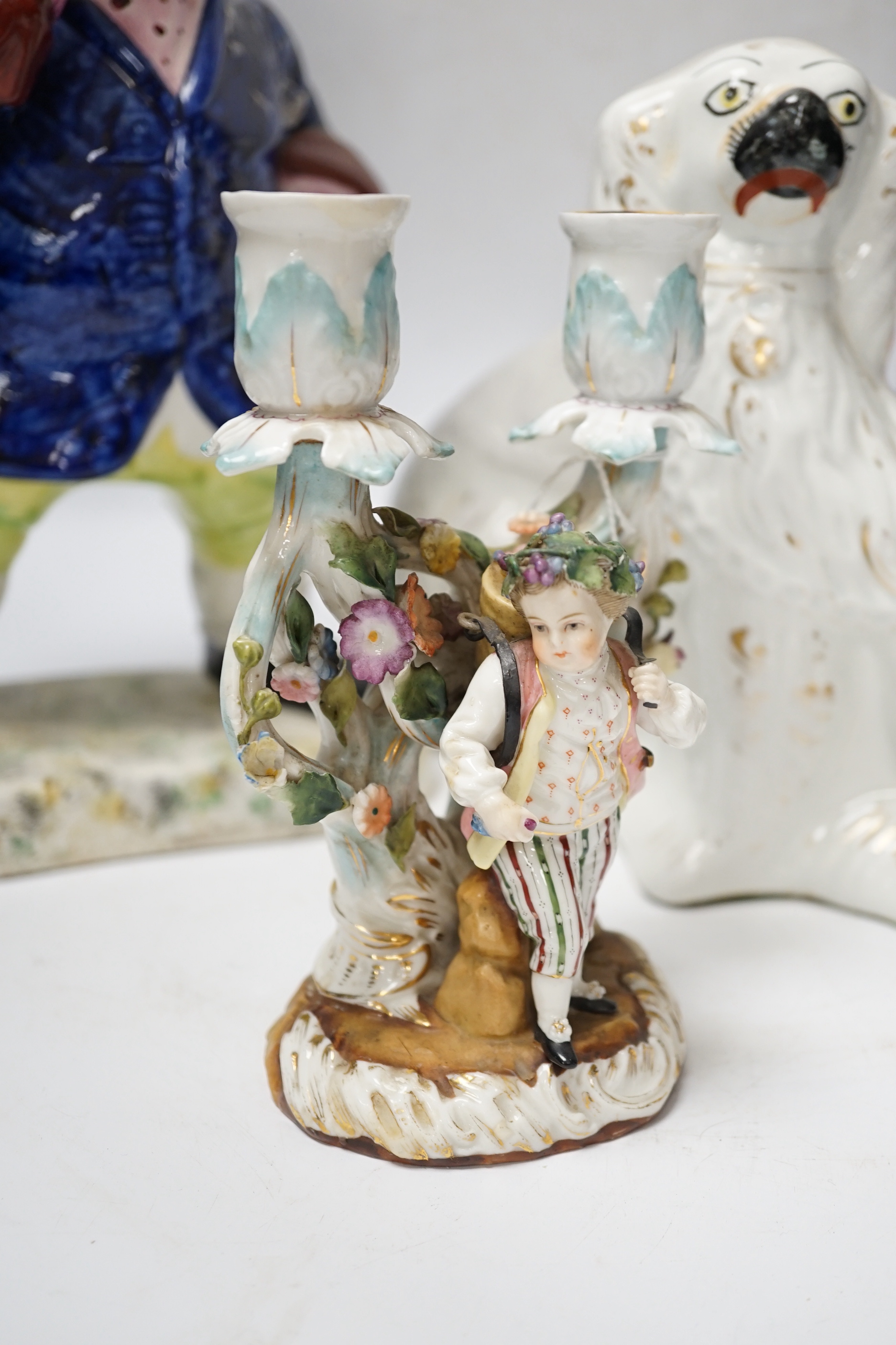 A pair of 19th century French figural two branch candelabra, 17cm high, together with two Staffordshire character jugs and a pair of Kings Charles Spaniel figures
